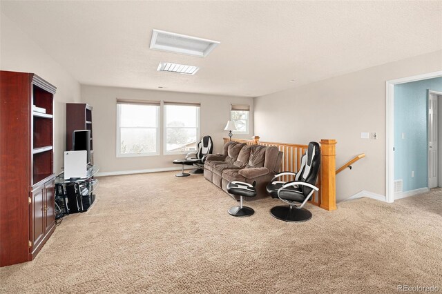 living room with baseboards, carpet floors, and attic access