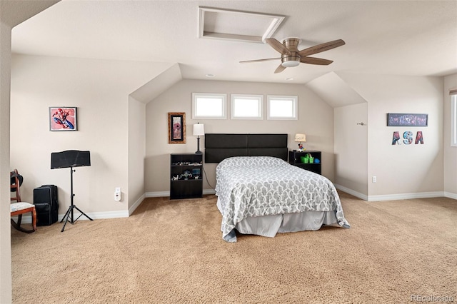 carpeted bedroom featuring baseboards, lofted ceiling, attic access, and ceiling fan