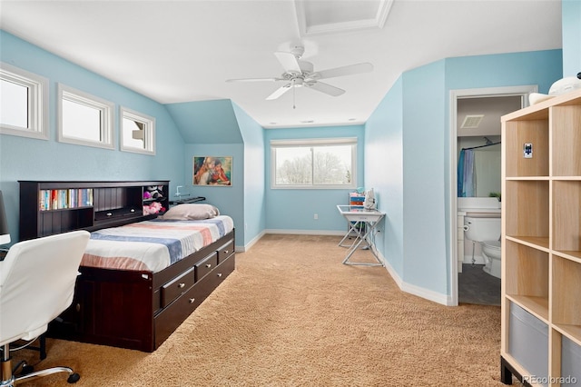 carpeted bedroom featuring vaulted ceiling, connected bathroom, baseboards, and ceiling fan