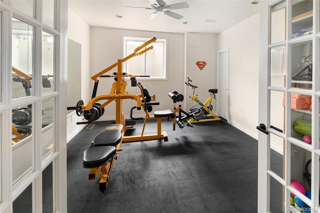 exercise room with french doors, baseboards, and a ceiling fan