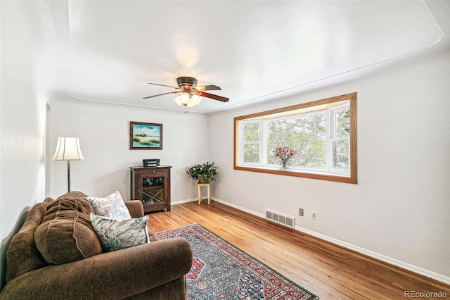 4285 Newland St, Wheat Ridge, CO 80033 - living room featuring light wood-type flooring, baseboards, and a ceiling fan