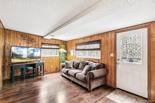 4285 Newland St, Wheat Ridge, CO 80033 - living area with a textured ceiling, wooden walls, and wood finished floors