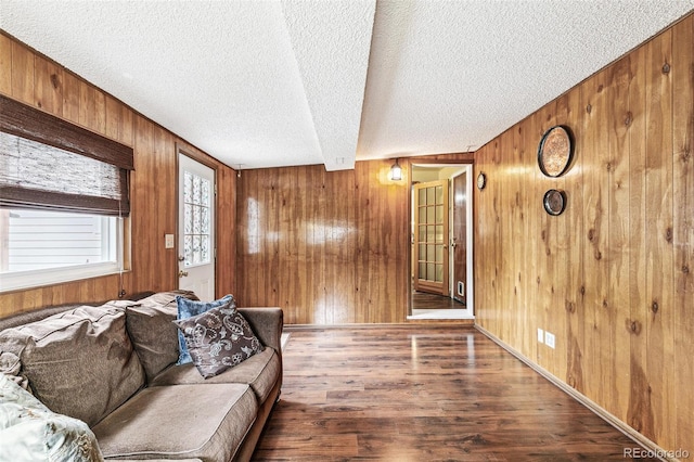 4285 Newland St, Wheat Ridge, CO 80033 - living room featuring wood walls, a textured ceiling, wood finished floors, and beam ceiling