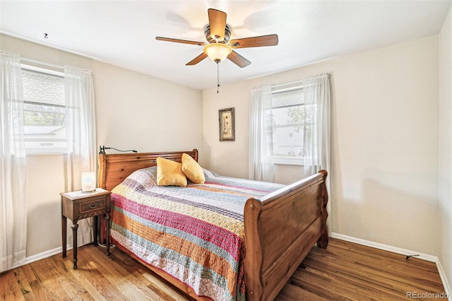 4285 Newland St, Wheat Ridge, CO 80033 - bedroom with baseboards, wood finished floors, and a ceiling fan