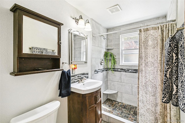 4285 Newland St, Wheat Ridge, CO 80033 - bathroom featuring toilet, a shower stall, and vanity