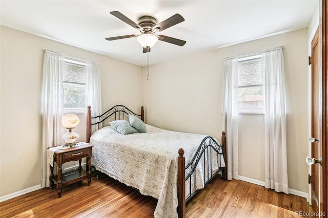 4285 Newland St, Wheat Ridge, CO 80033 - bedroom with wood finished floors, baseboards, and a ceiling fan
