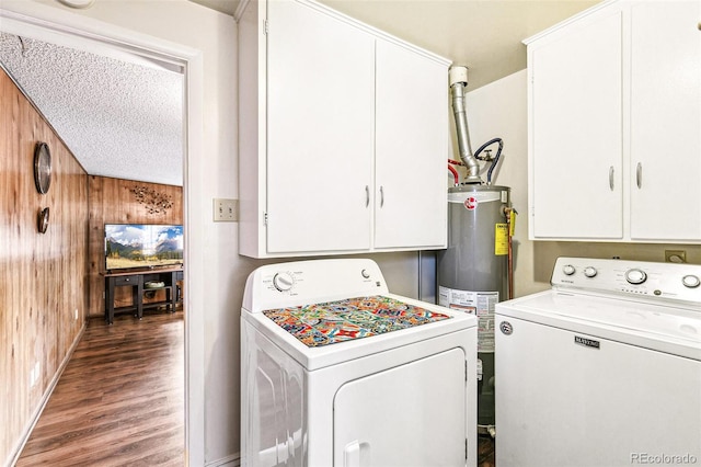 4285 Newland St, Wheat Ridge, CO 80033 - laundry area with washer and dryer, water heater, wooden walls, cabinet space, and wood finished floors