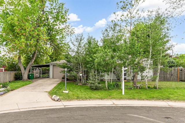 4285 Newland St, Wheat Ridge, CO 80033 - view of front facade with a carport, concrete driveway, and a garage