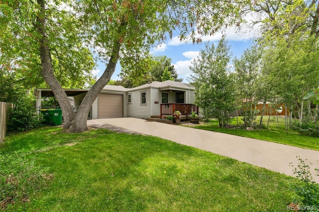 4285 Newland St, Wheat Ridge, CO 80033 - view of front of home with concrete driveway, an attached garage, and a porch