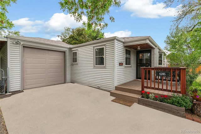 4285 Newland St, Wheat Ridge, CO 80033 - view of front of home featuring an attached garage and driveway