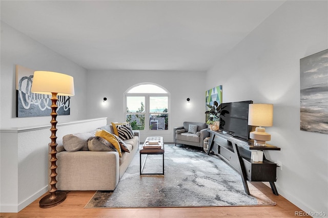 living area with wood finished floors and baseboards