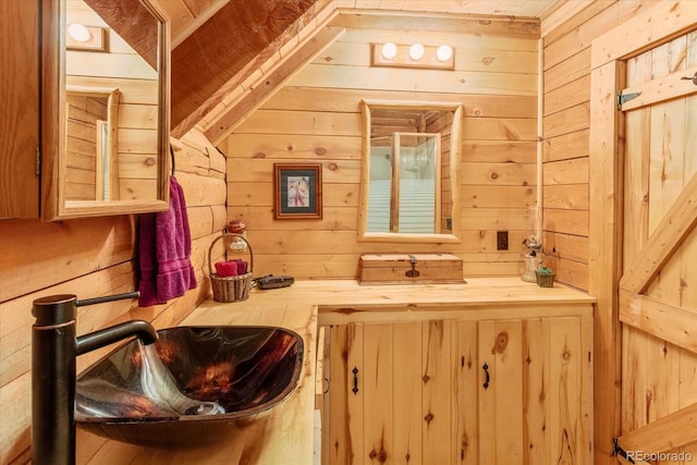 bathroom featuring vanity and wood walls