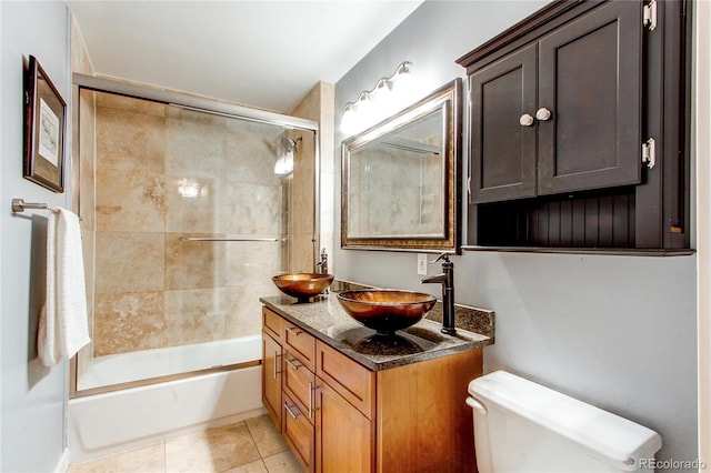 full bathroom featuring vanity, toilet, tile patterned floors, and tiled shower / bath combo