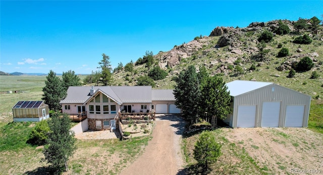 exterior space with an outdoor structure, a garage, and a rural view