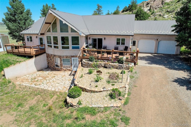 exterior space with a wooden deck and a garage