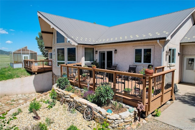 rear view of property with a wooden deck