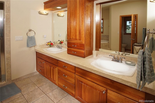 bathroom with tile patterned flooring, vanity, and toilet