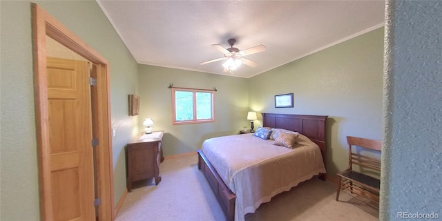 carpeted bedroom with crown molding and ceiling fan