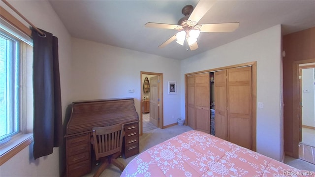 carpeted bedroom with a closet and ceiling fan