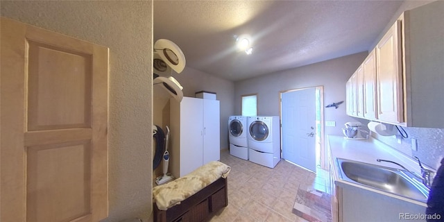 clothes washing area with washer and dryer and sink