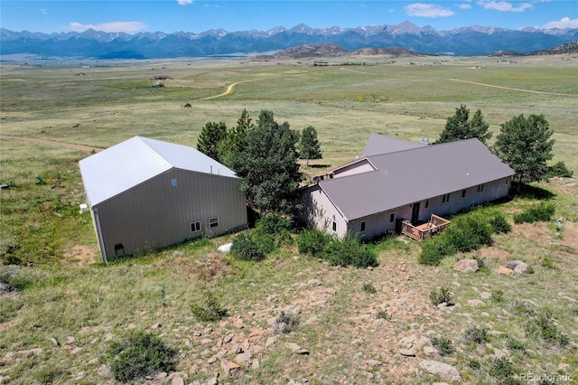 birds eye view of property with a mountain view and a rural view