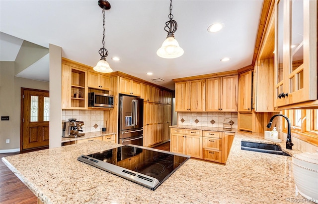 8788 E Tanglewood Rd, Franktown, CO 80116 - kitchen with appliances with stainless steel finishes, a sink, a peninsula, light brown cabinetry, and light stone counters