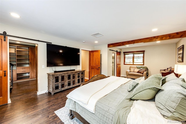 8788 E Tanglewood Rd, Franktown, CO 80116 - bedroom with a barn door, dark wood-style floors, recessed lighting, and baseboards