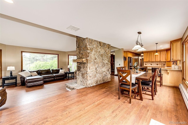8788 E Tanglewood Rd, Franktown, CO 80116 - dining space with light wood-style flooring and baseboard heating