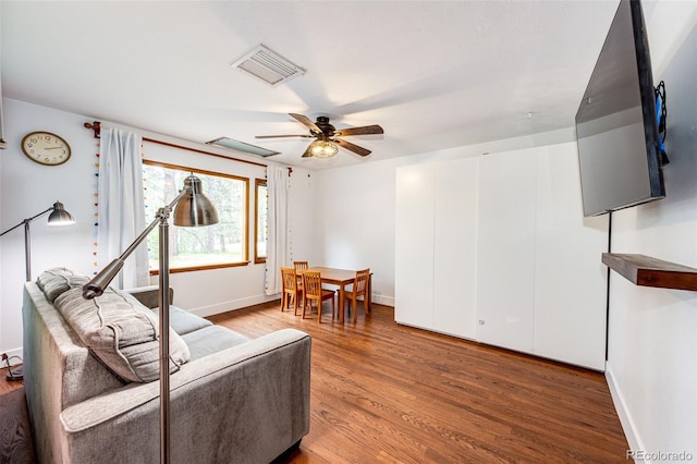 8788 E Tanglewood Rd, Franktown, CO 80116 - living room featuring wood finished floors, ceiling fan, and baseboards