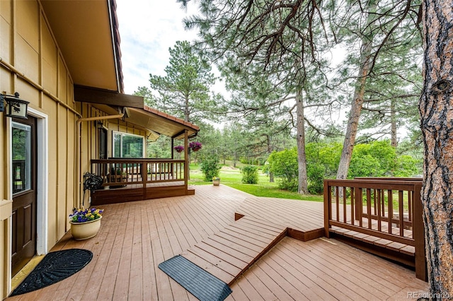 8788 E Tanglewood Rd, Franktown, CO 80116 - wooden terrace featuring view of wooded area