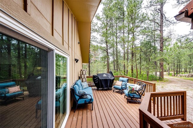 8788 E Tanglewood Rd, Franktown, CO 80116 - wooden deck featuring an outdoor living space and grilling area