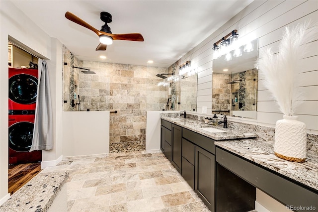 8788 E Tanglewood Rd, Franktown, CO 80116 - full bath with walk in shower, stacked washer / drying machine, ceiling fan, and double vanity