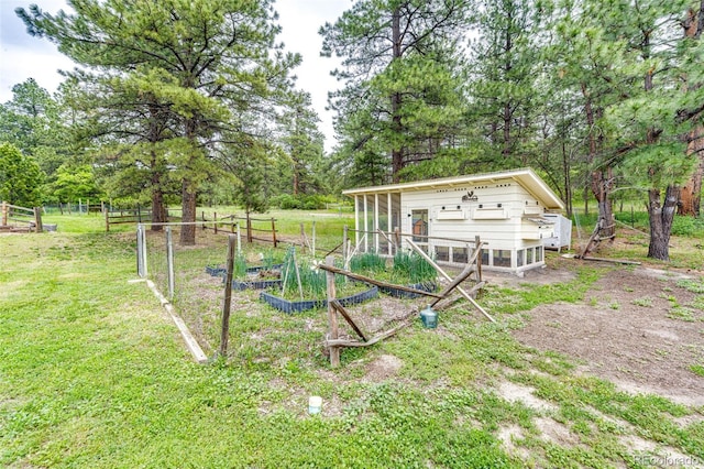 8788 E Tanglewood Rd, Franktown, CO 80116 - view of yard featuring a vegetable garden, exterior structure, an outbuilding, and view of scattered trees