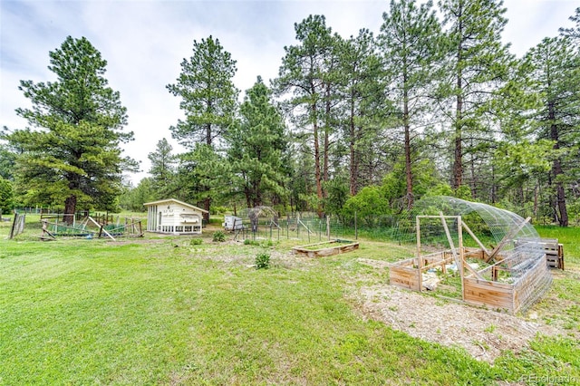 8788 E Tanglewood Rd, Franktown, CO 80116 - view of grassy yard featuring a vegetable garden and an outbuilding