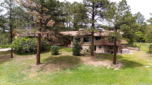 8788 E Tanglewood Rd, Franktown, CO 80116 - view of green lawn with a wooden deck and a patio area