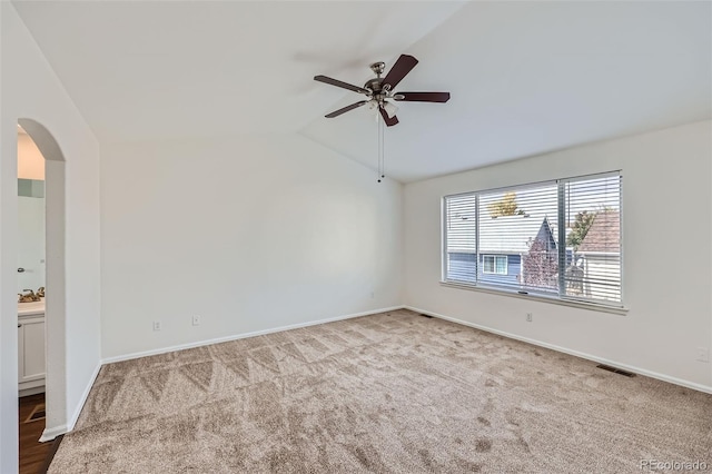 unfurnished room featuring lofted ceiling, light carpet, and ceiling fan