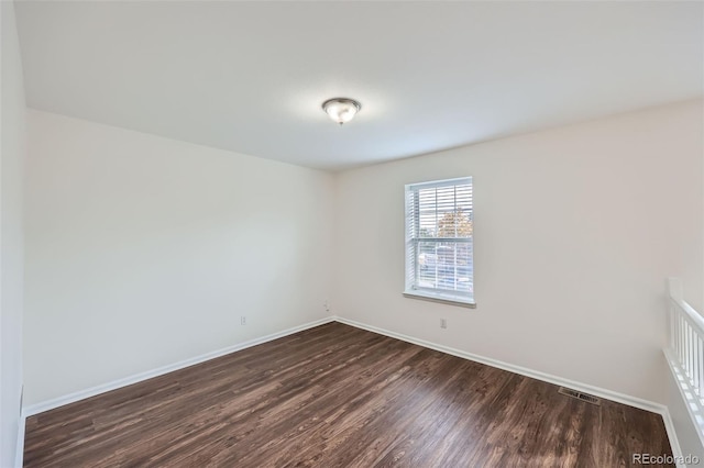 empty room featuring dark wood-type flooring