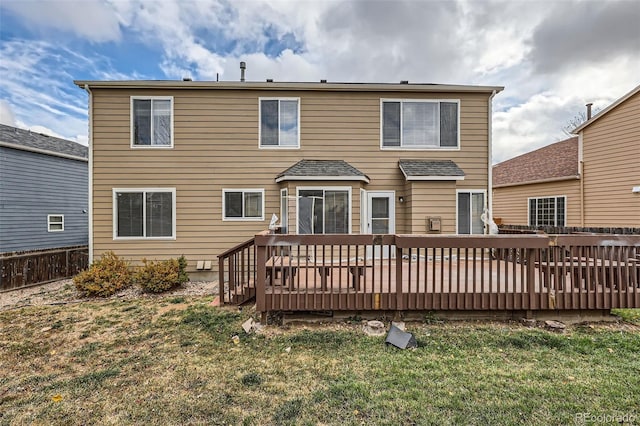 back of house featuring a yard and a wooden deck