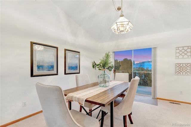 dining space featuring visible vents, light colored carpet, lofted ceiling, and baseboards