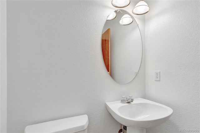 bathroom with toilet and sink