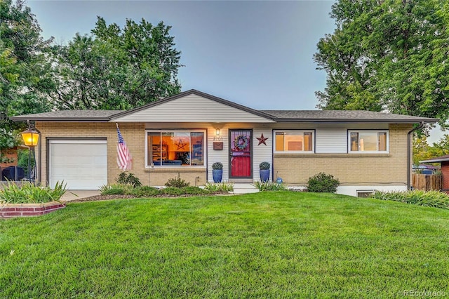 ranch-style home with a front yard and a garage