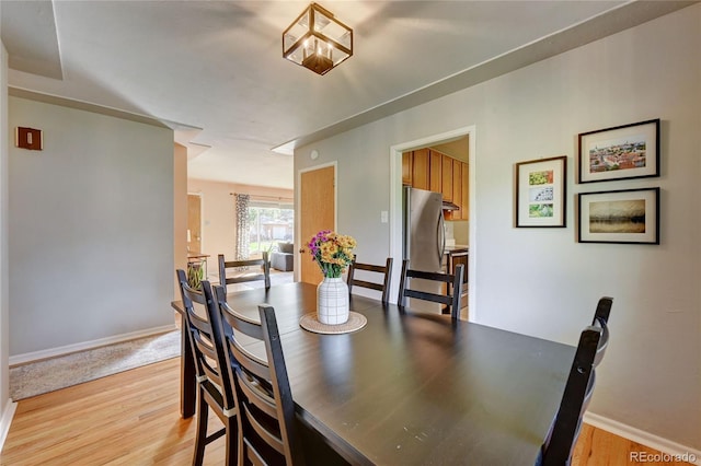 dining area featuring light wood-type flooring