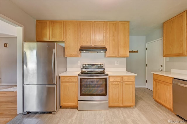 kitchen with appliances with stainless steel finishes, light brown cabinetry, and light hardwood / wood-style floors