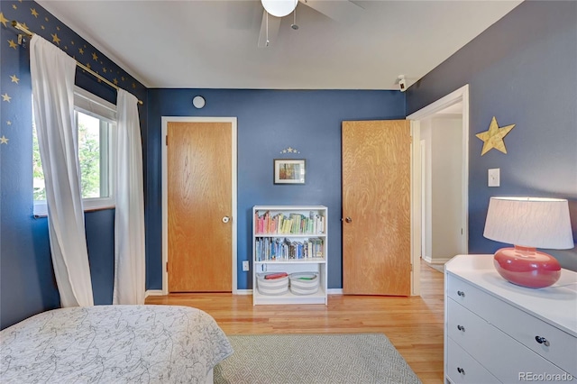 bedroom with ceiling fan and light wood-type flooring