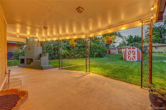 view of patio featuring an outdoor brick fireplace and a shed