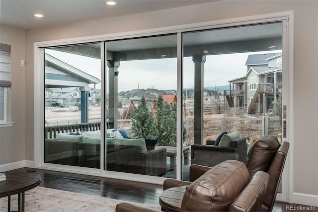 entryway with recessed lighting, wood finished floors, and baseboards