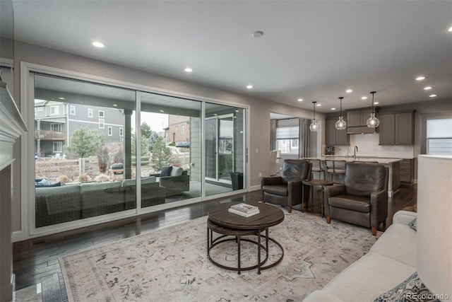 living area with light wood-type flooring and recessed lighting