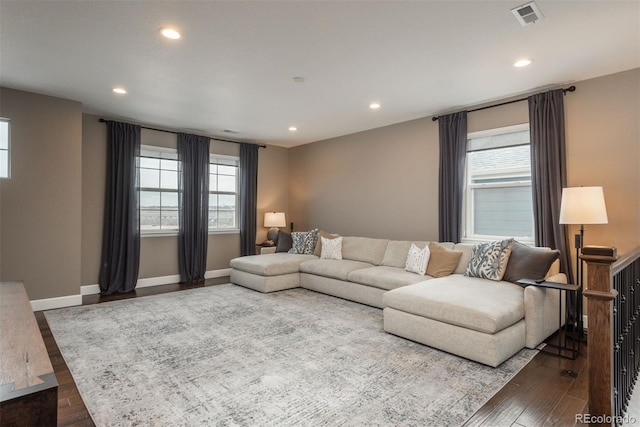 living area with recessed lighting, visible vents, baseboards, and wood finished floors