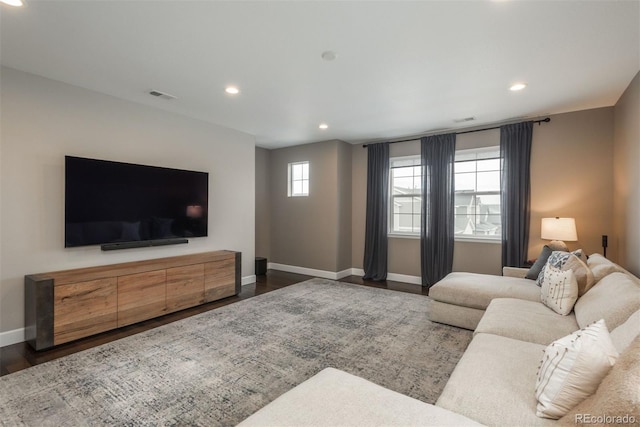 living room with baseboards, visible vents, dark wood-style flooring, and recessed lighting