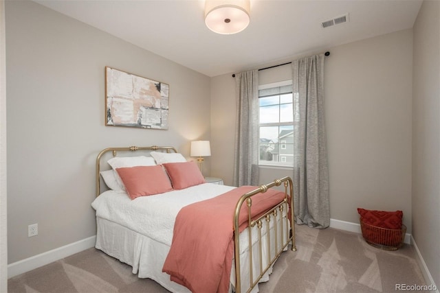 bedroom with carpet floors, baseboards, and visible vents